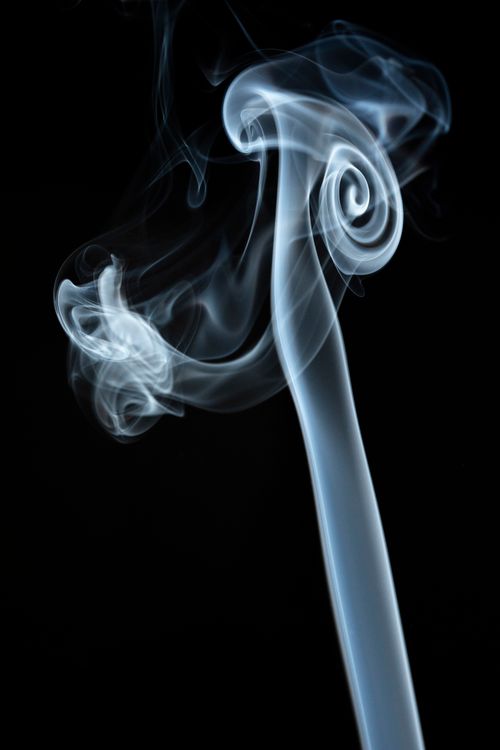 Free Abstract close-up of swirling smoke patterns on black background. Stock Photo