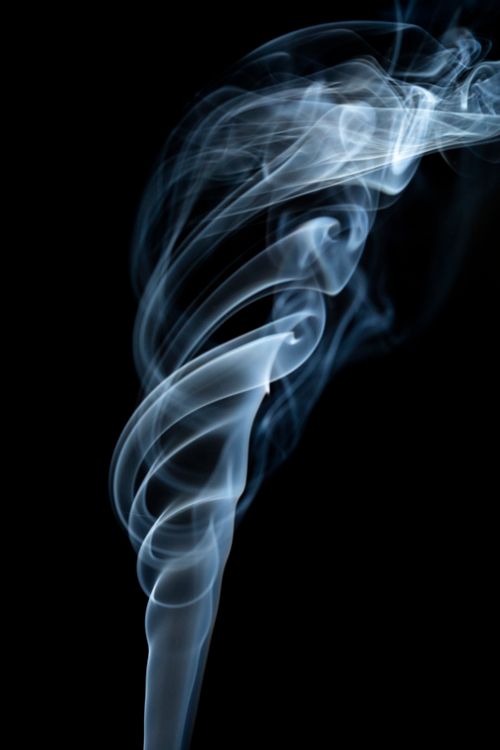 Free Captivating image of swirling blue smoke on a stark black background, creating a mesmerizing abstract form. Stock Photo