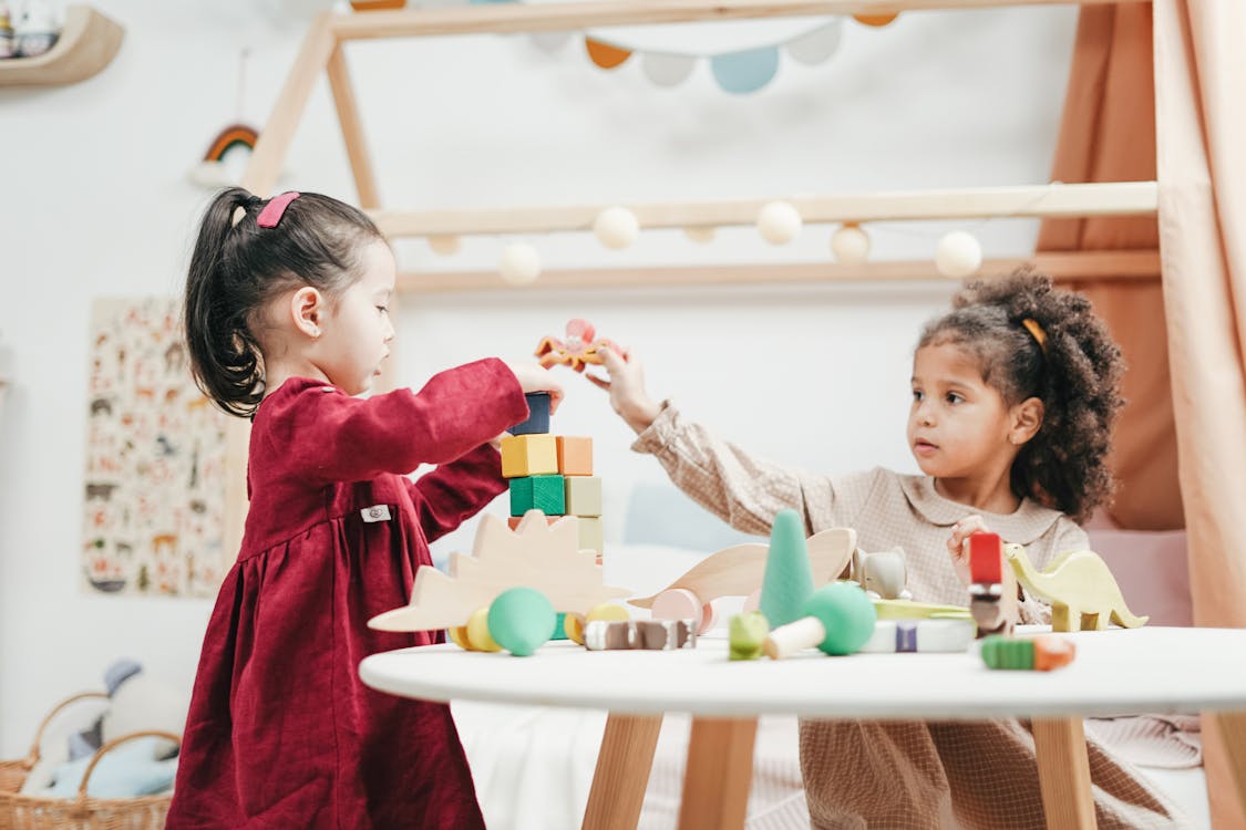 Free Girl In Red Dress Playing A wooden Blocks Stock Photo