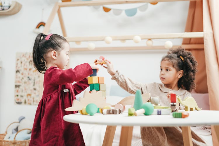 Girl In Red Dress Playing A Wooden Blocks