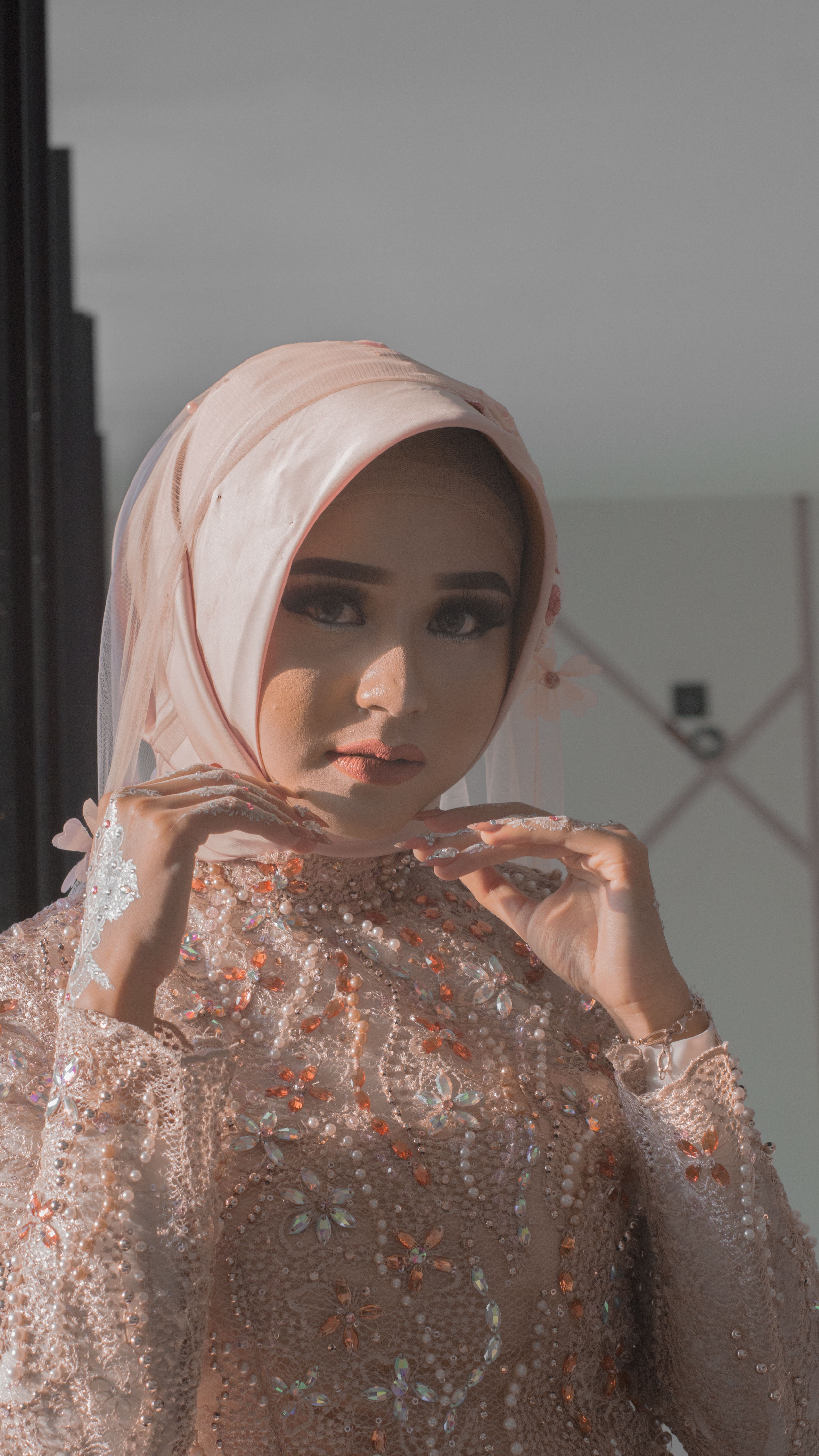 Portrait of a young Indonesian woman in ornate attire with hijab, showcasing cultural elegance.