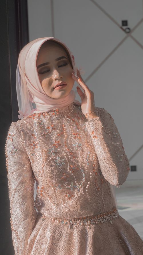 Free A young woman in a beautiful embellished dress and hijab, captured in soft, natural light. Stock Photo