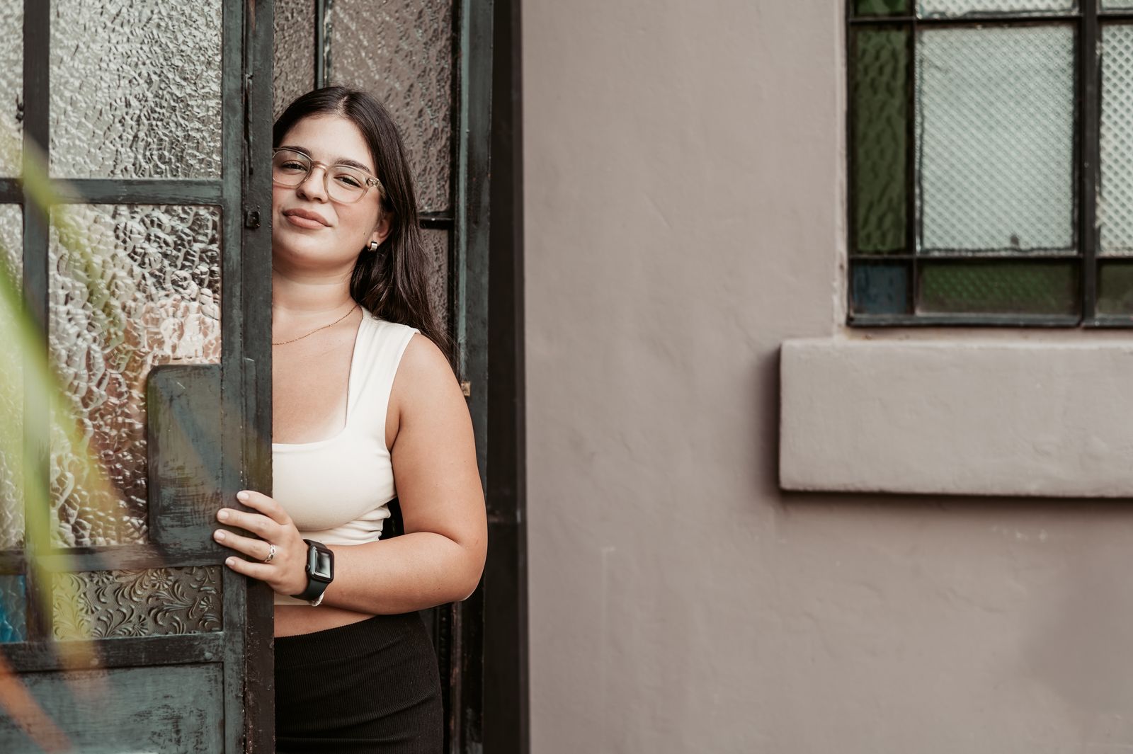 Young woman smiling at an open doorway