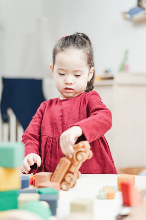 Little Girl Playing with Toys