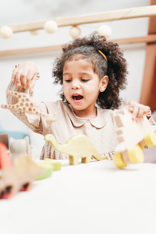 Free Girl Holding Wooden Toy is Singing Stock Photo