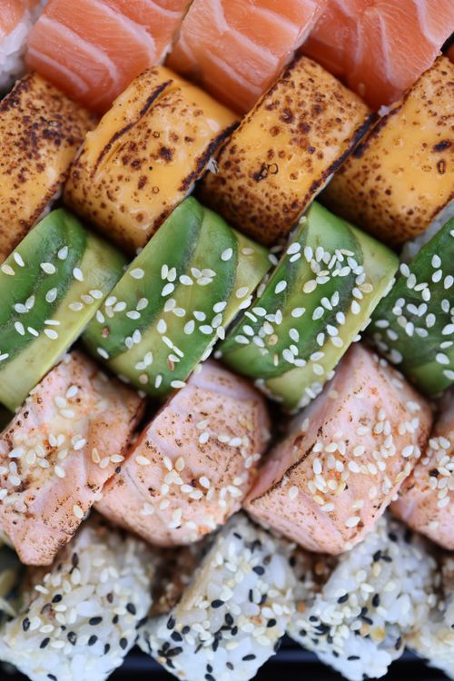 Free Detailed view of colorful sushi rolls with sesame seeds, perfect for cuisine-themed designs. Stock Photo