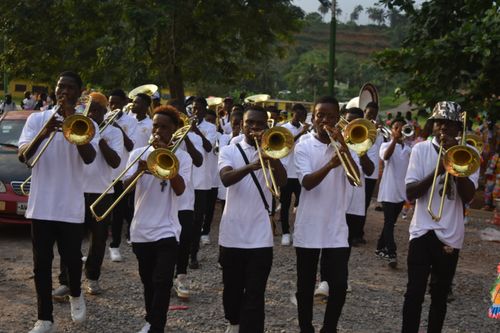 Free A group of young musicians playing brass instruments in an outdoor parade. Stock Photo