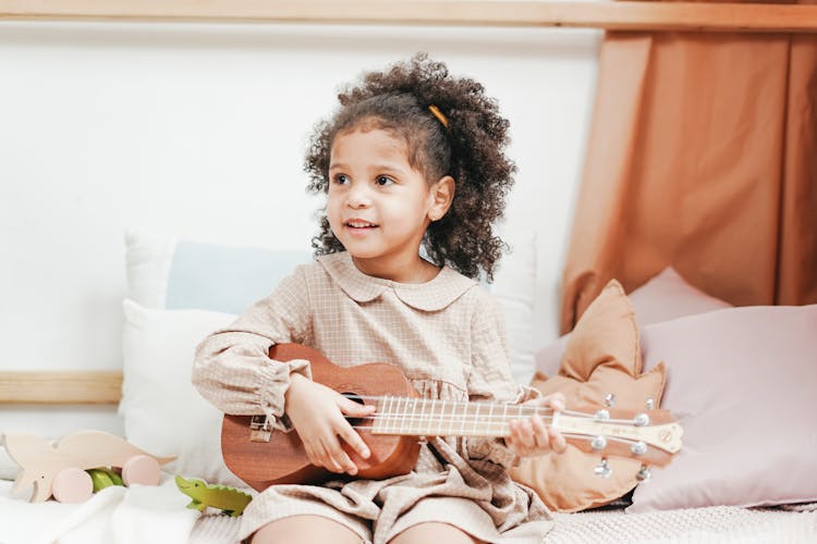 Ukulele Played By A Young Girl