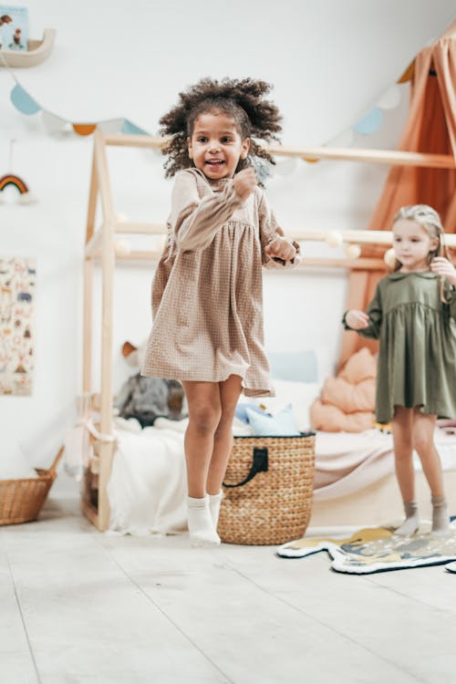 Girl Wearing Brown Dress While Jumping