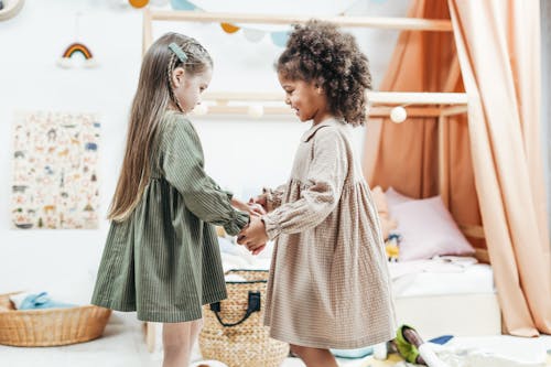 Free Photo of Girls Wearing Dress While Holding Hands Stock Photo