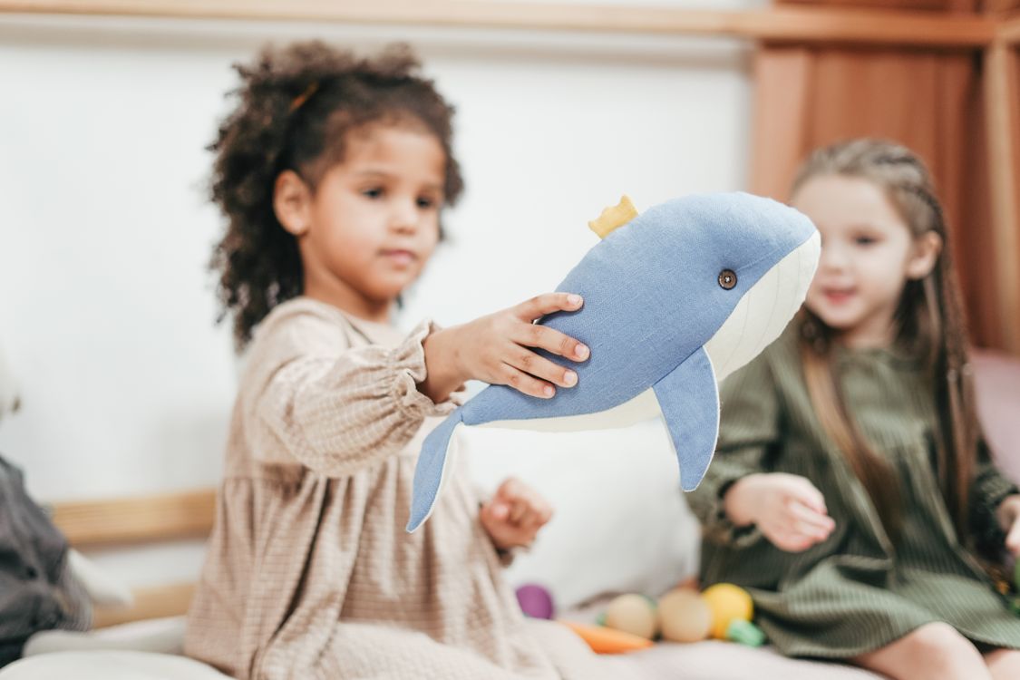 Free Shallow Focus Photo of Girl Holding Stuffed Toy Stock Photo