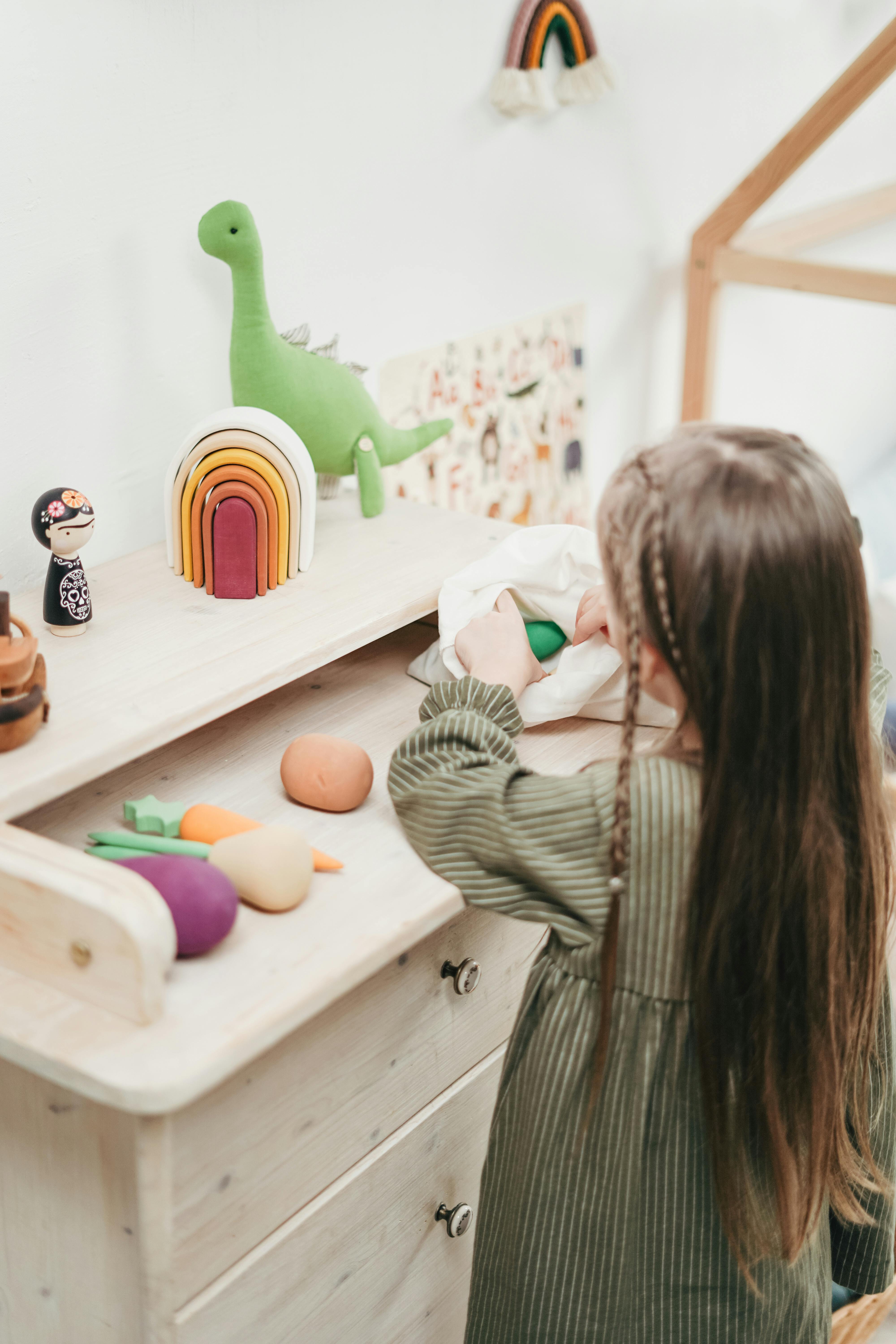 photo of a girl playing with her toys