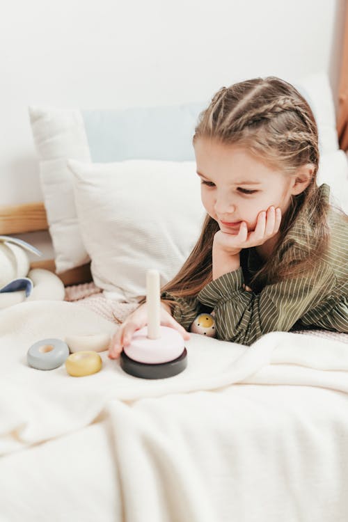 Free Girl Lying on White Bed Stock Photo