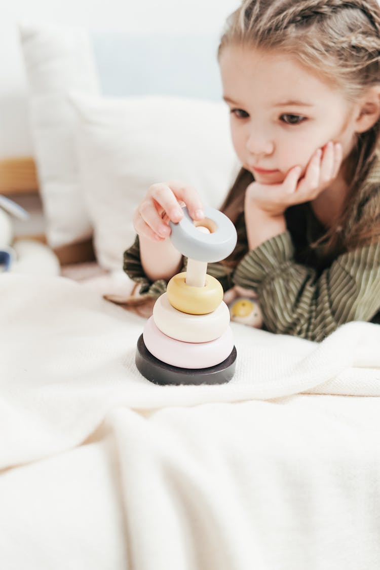 Girl Playing With Wooden Stacking Toy