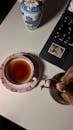 Elegant Tea Setup with Laptop and Vase