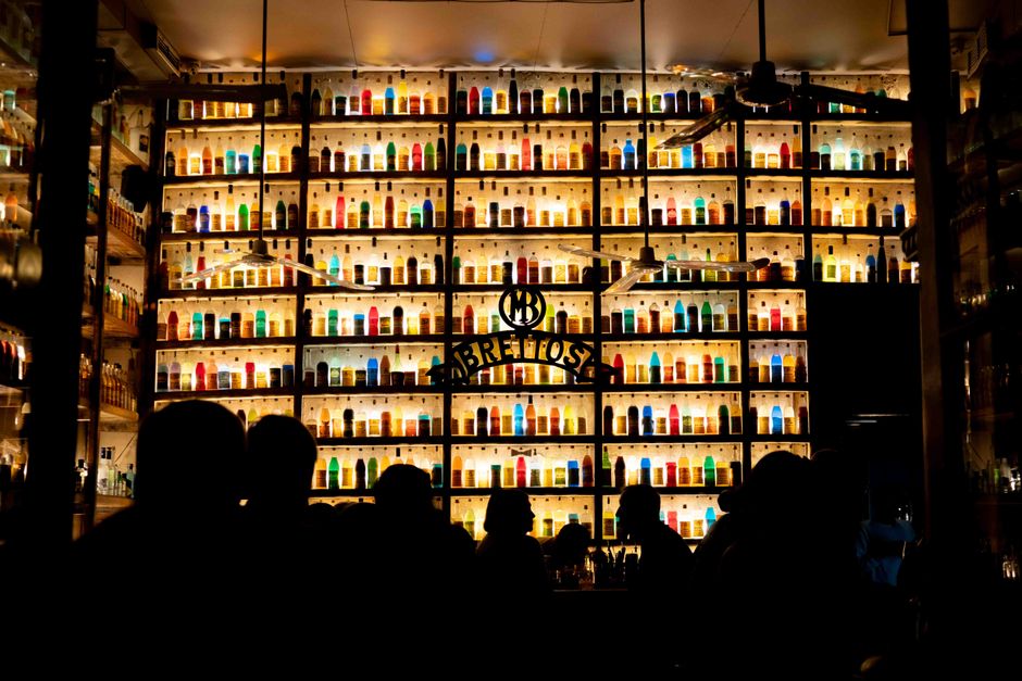 Gazi Athens nightlife clubs bars - colorful bar scene with bottles and silhouettes