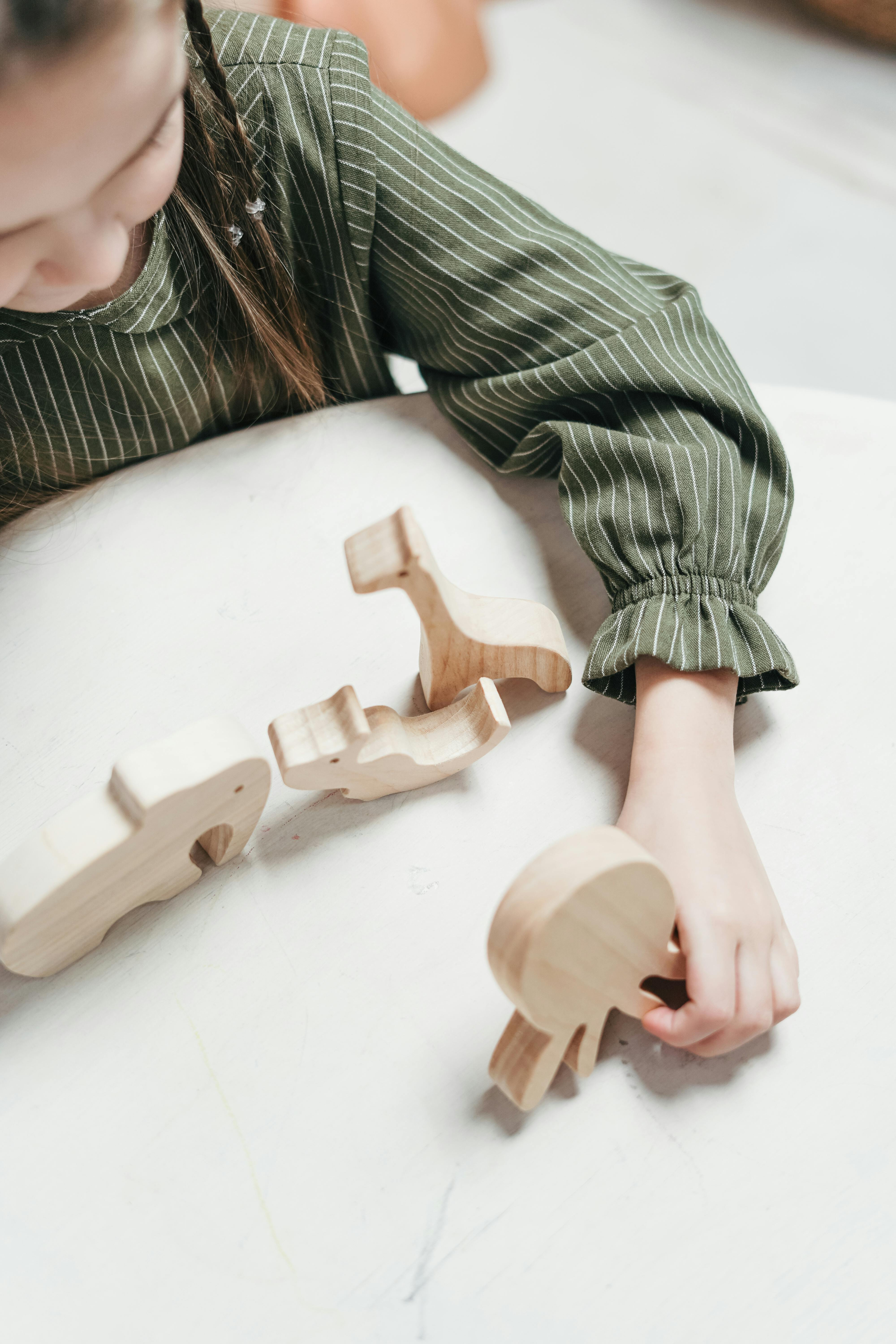 girl holding a wooden octopus