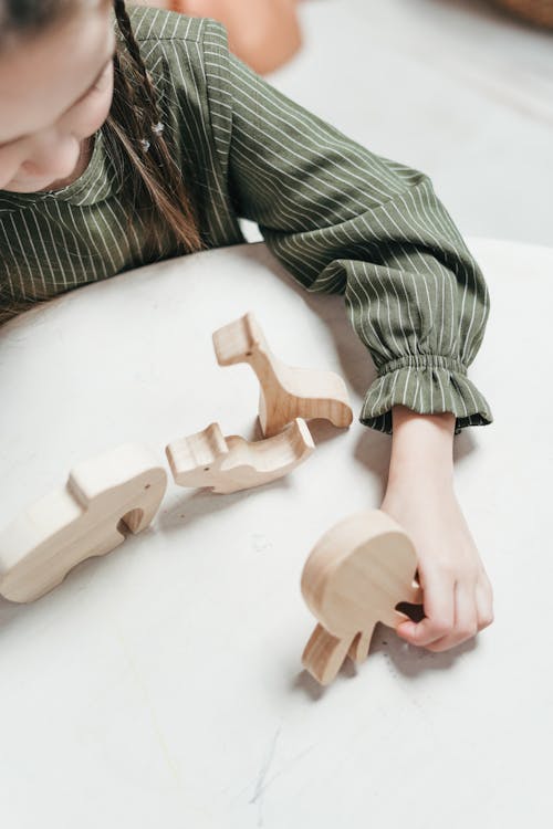 Girl Holding a Wooden Octopus