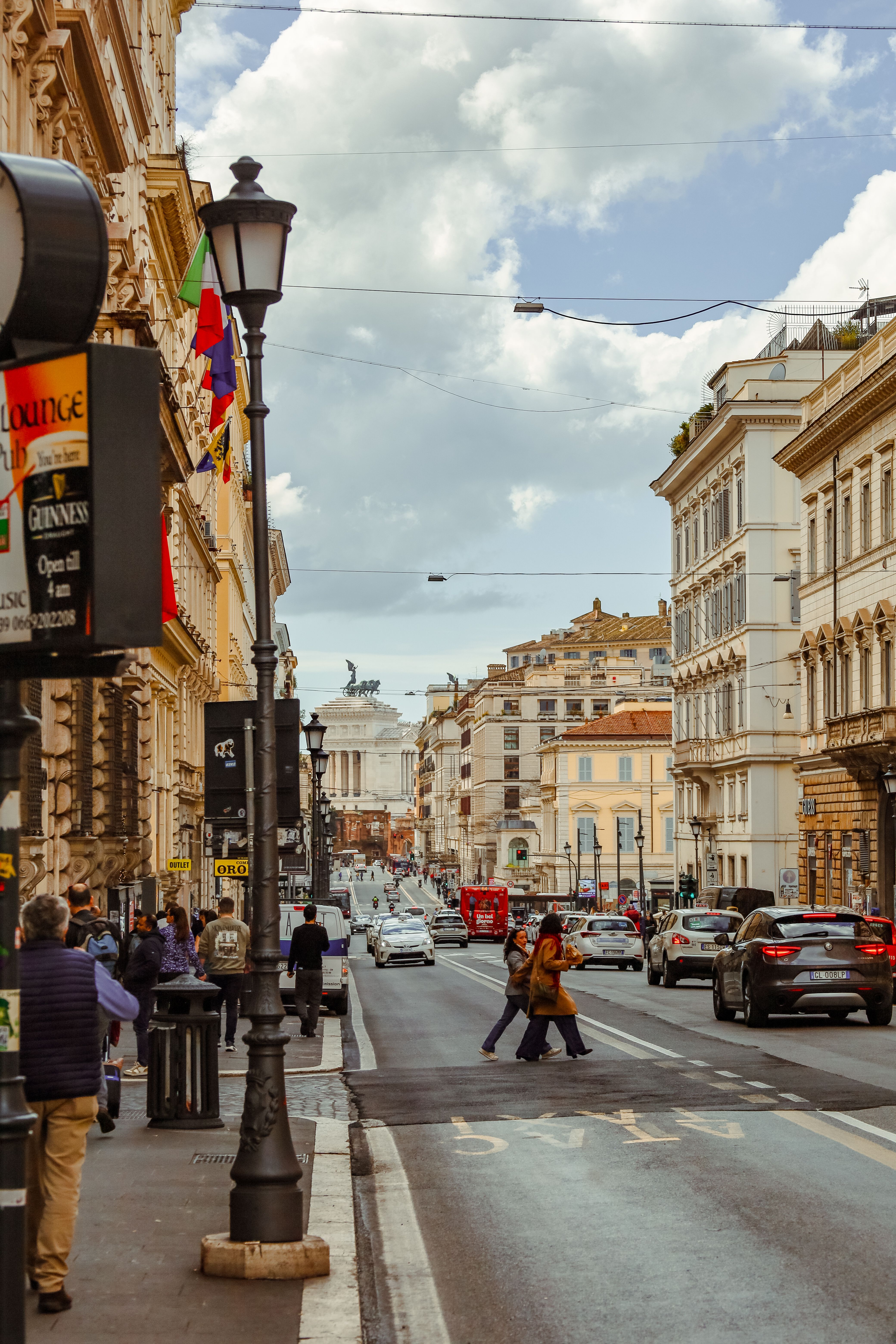 Vibrant street view of Rome featuring classic architecture and bustling city life.