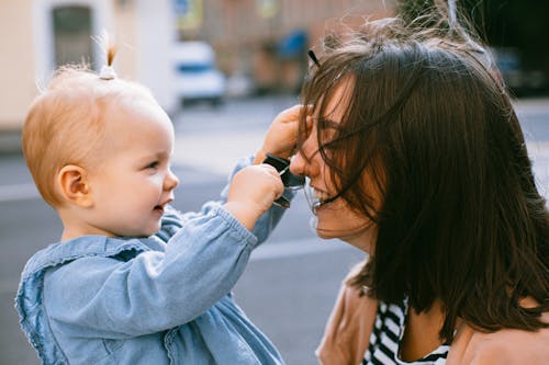 Photo of Woman and Her Daughter Laughing