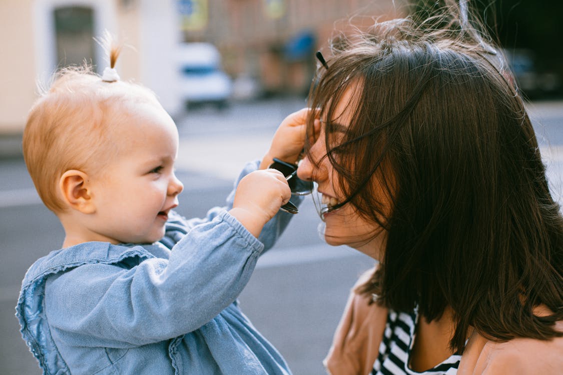 Photo of Woman and Her Daughter Laughing