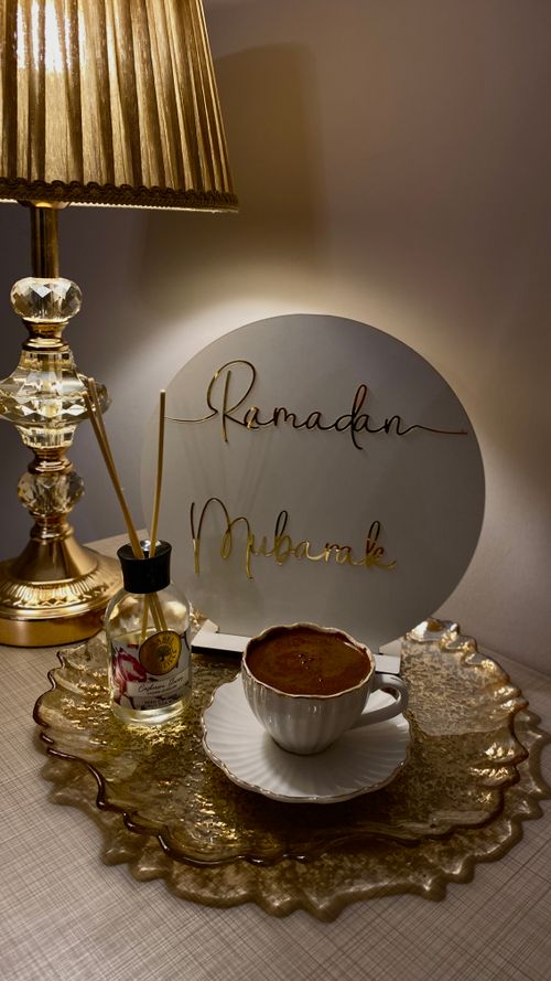 Free A cozy coffee setup with Ramadan Mubarak sign, lamp, and diffuser. Stock Photo