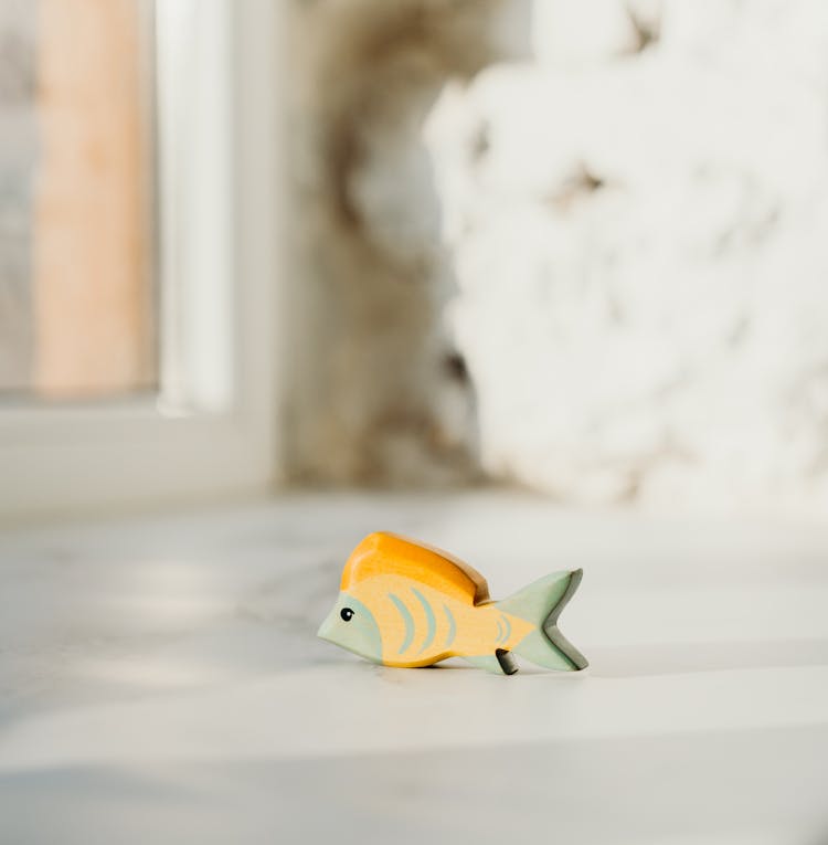 Shallow Focus Photo Of Wooden Fish Toy