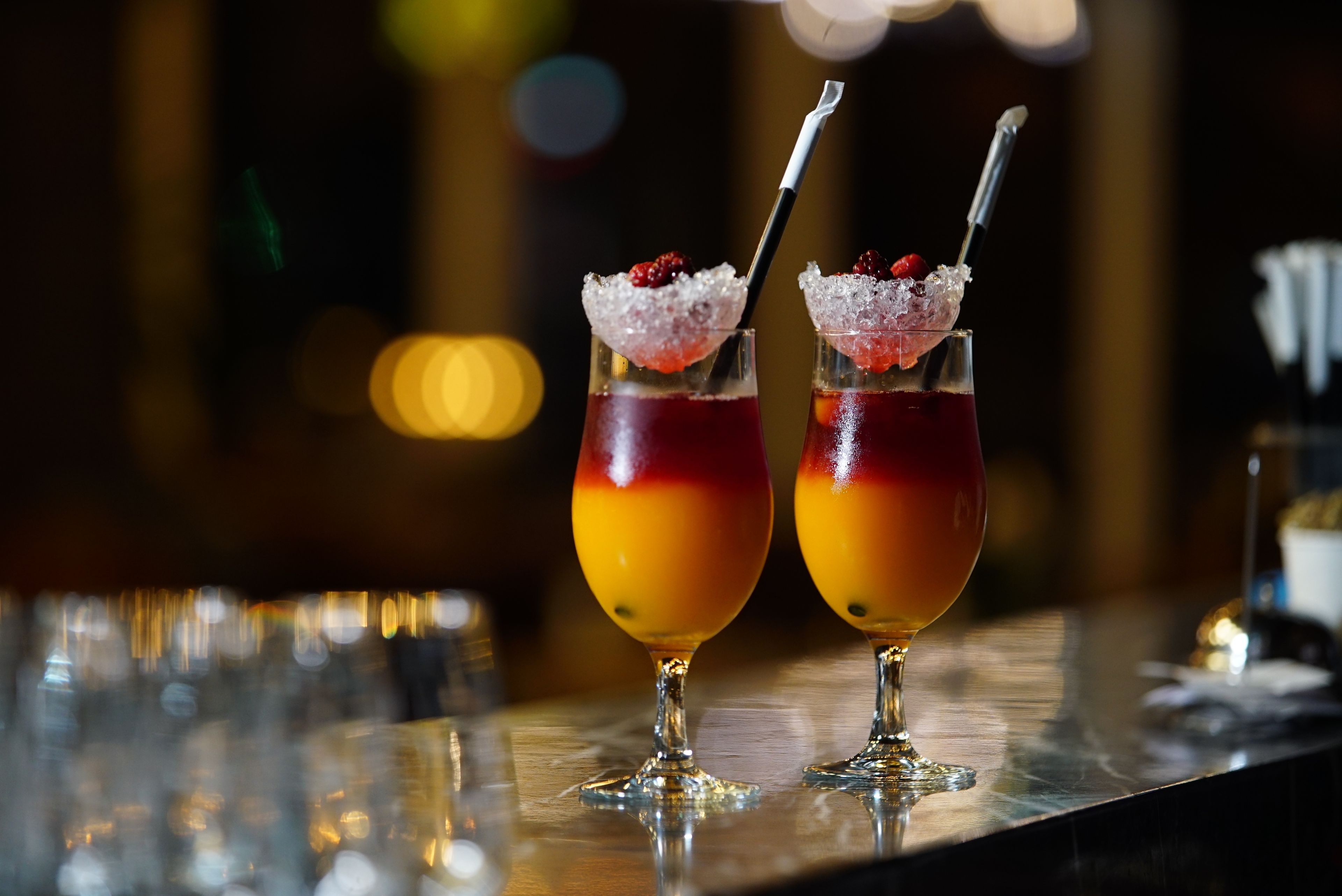 Two berry cocktails over ice