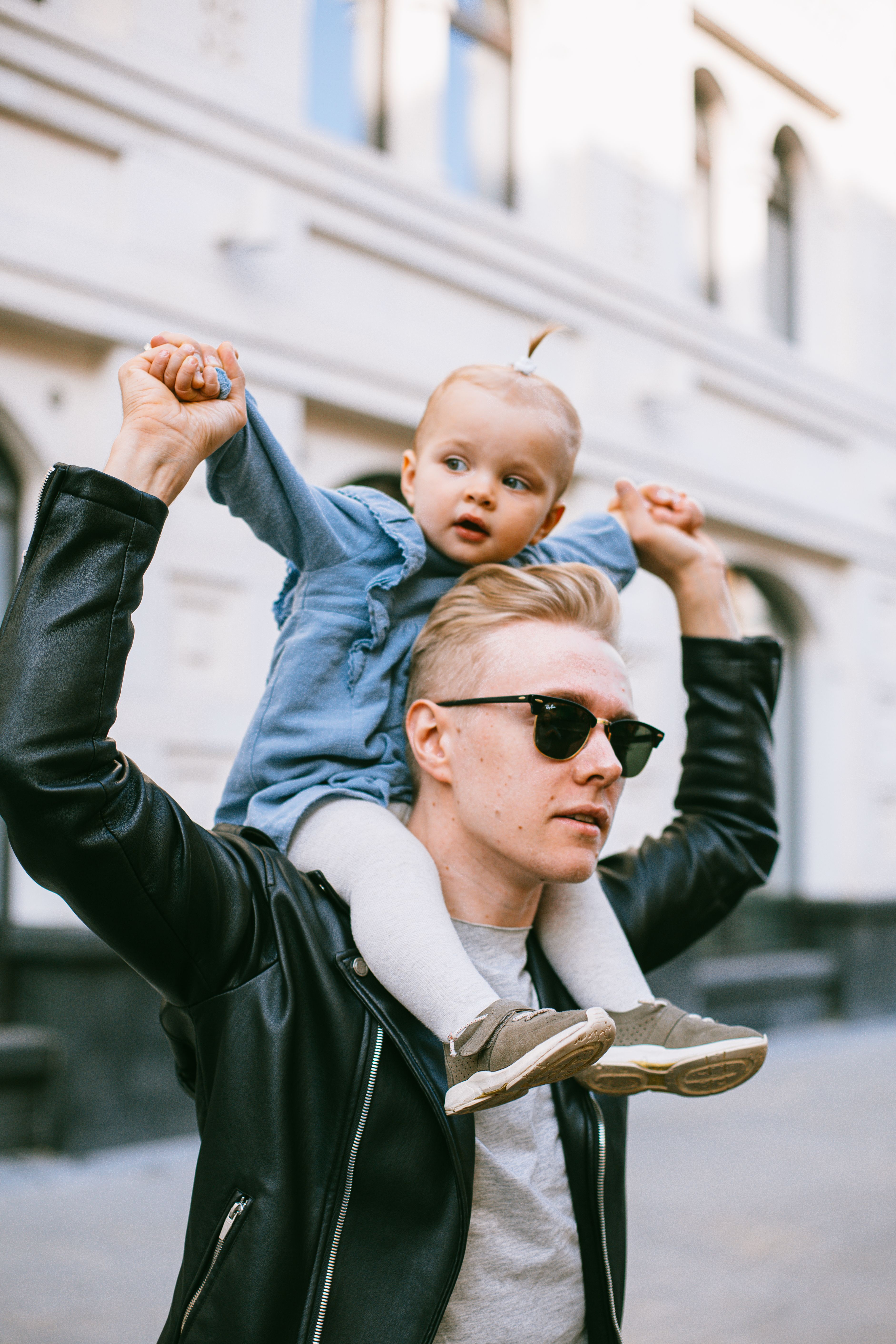 Man In Black Leather Jacket Carrying Baby 