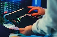 Trader Analyzing Stock Market Trends on Tablet