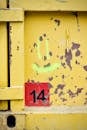 Weathered Yellow Metal with Number 14 and Graffiti