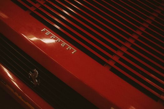 Detailed close-up view of a classic Ferrari's hood, showcasing its iconic design and luxury appeal.