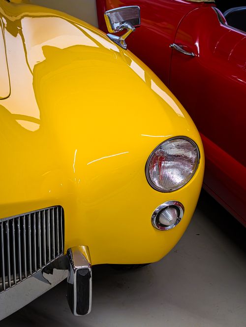 Free Detailed view of vintage yellow car beside red car in Fichtelberg, Germany. Stock Photo