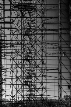Intricate black and white scaffolding structure against the sky in Fougères, Bretagne, France.