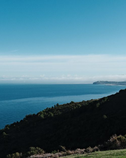 Free Expansive coastal view with a blue sky and distant horizon, perfect for nature and travel themes. Stock Photo