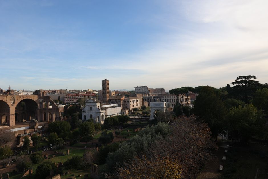 Scenic aerial view of Roman Forum and Colosseum in Rome, Italy, showcasing iconic landmarks.