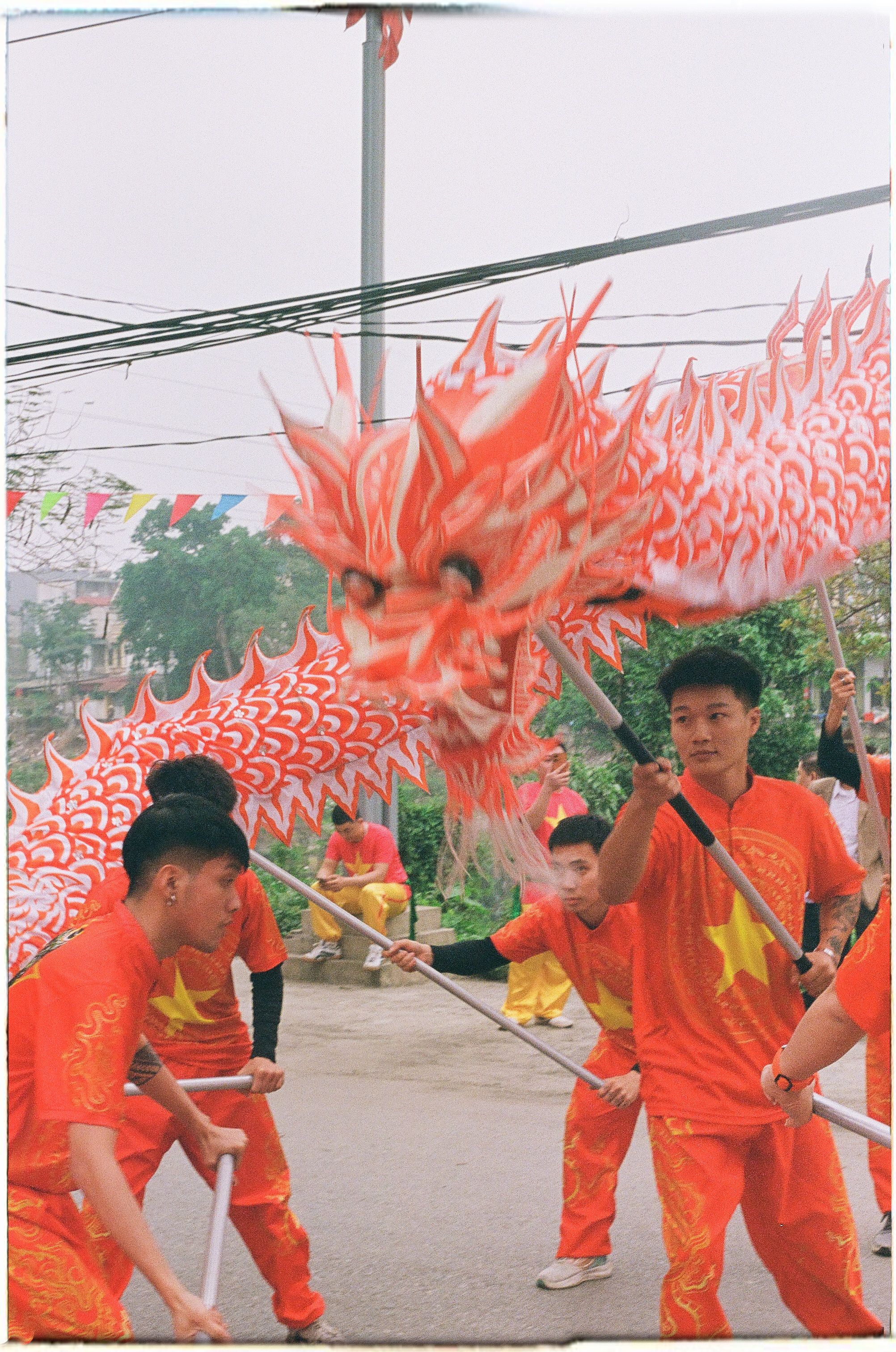 Colorful dragon dance during a festive parade in Vietnam, capturing cultural vibrancy.
