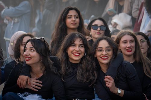 Free A group of diverse young women smiling and enjoying their time together outdoors. Stock Photo