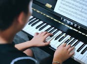 Young Pianist Playing at a Yamaha Piano