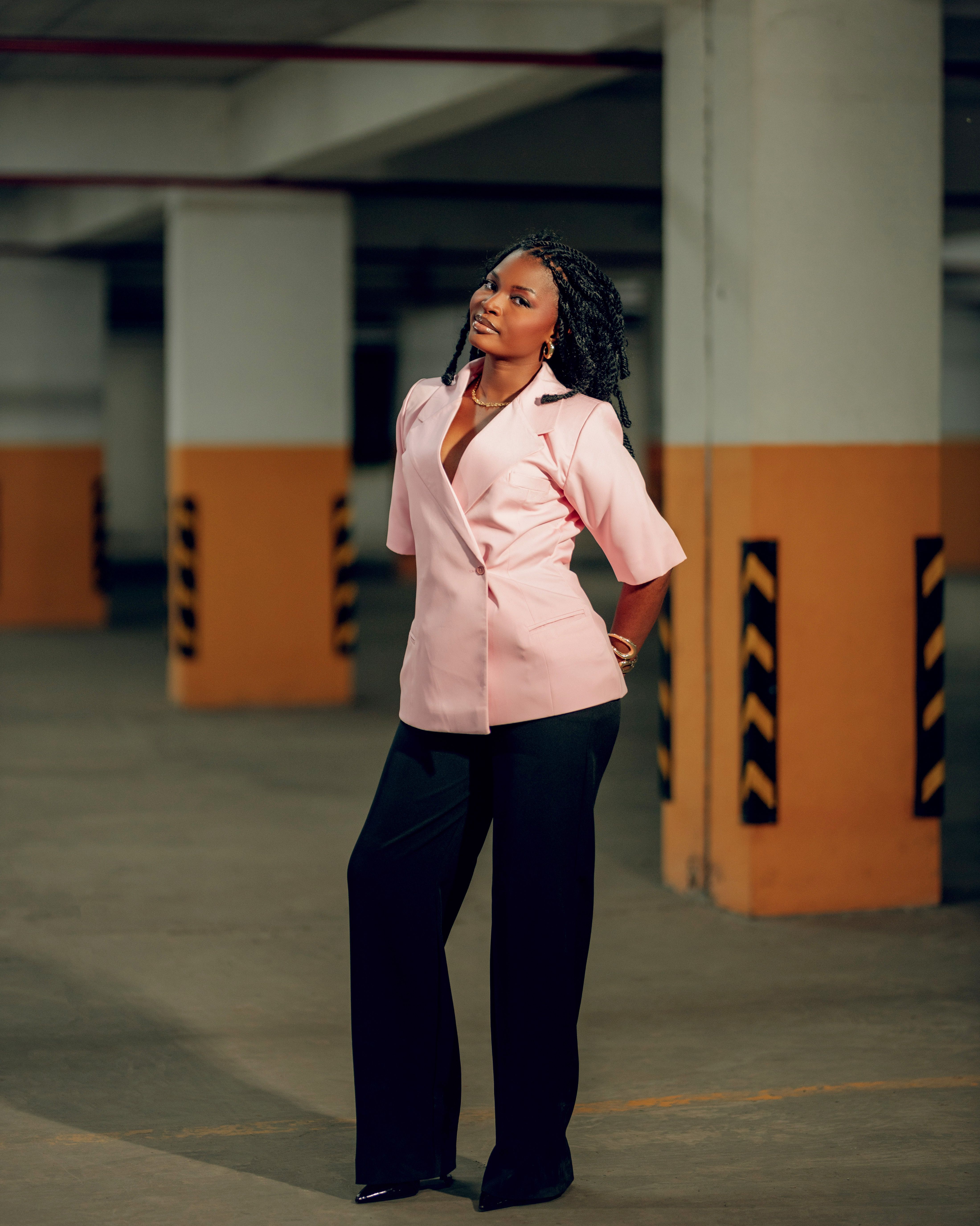 Stylish Woman Posing Indoors in Urban Setting · Free Stock Photo