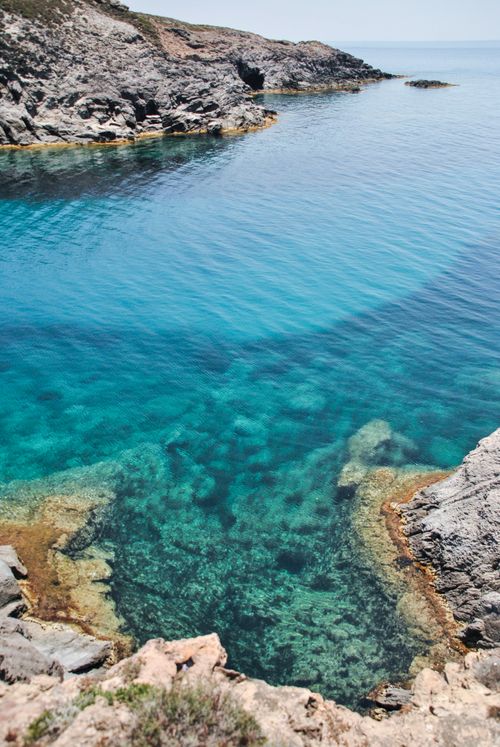 Free Beautiful turquoise waters of a rocky Sardinian cove, perfect for summer inspiration. Stock Photo