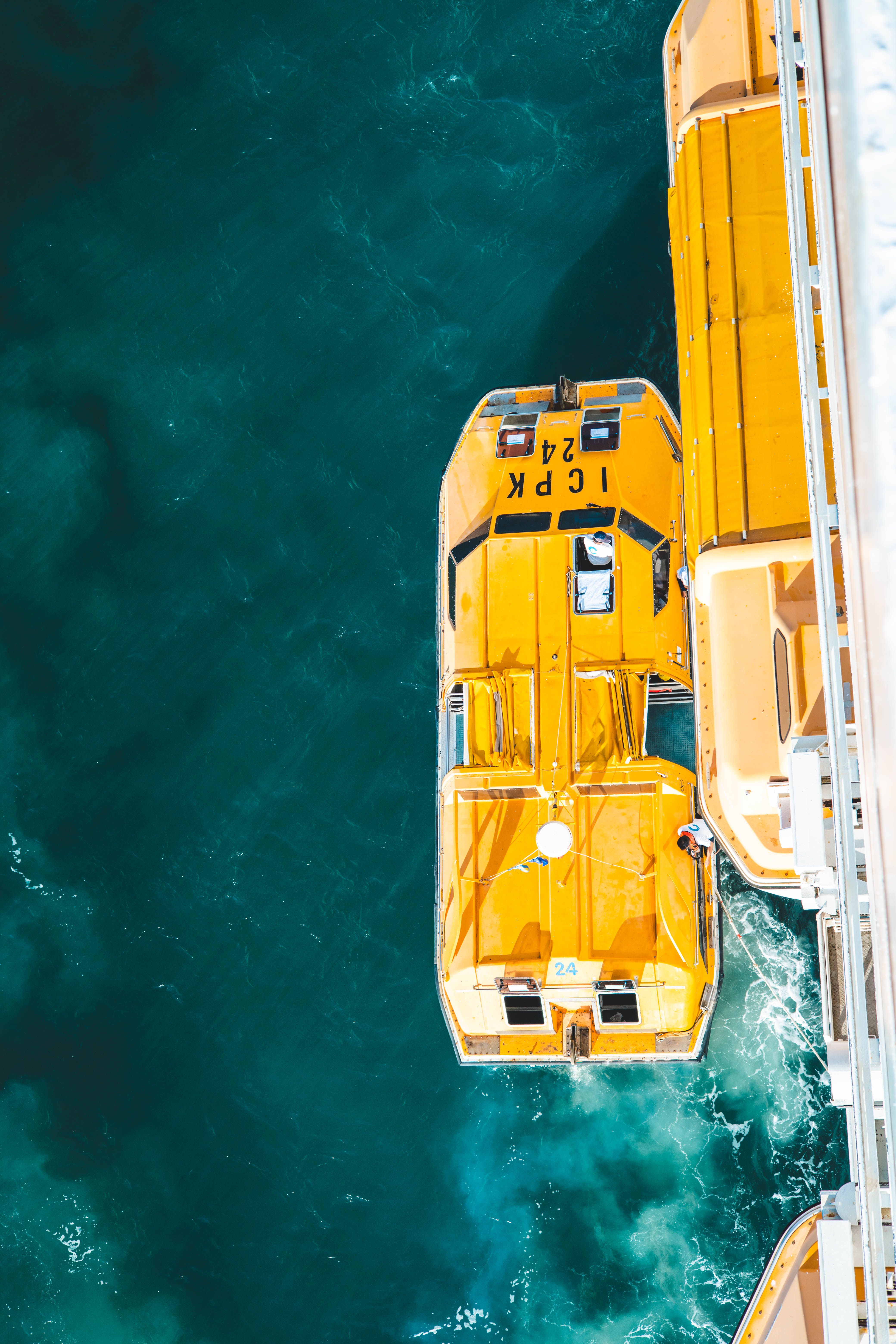 Aerial View of Yellow Lifeboat on Blue Ocean Water · Free Stock Photo