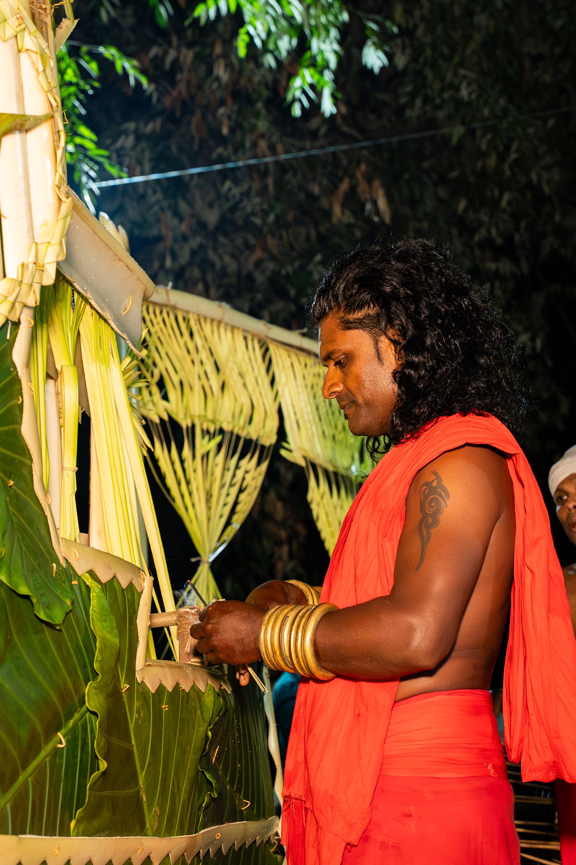 A man adorned in traditional attire performing a ritual, showcasing Sri Lankan culture.