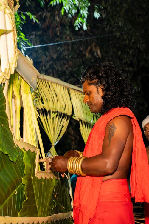 Free A man adorned in traditional attire performing a ritual, showcasing Sri Lankan culture. Stock Photo