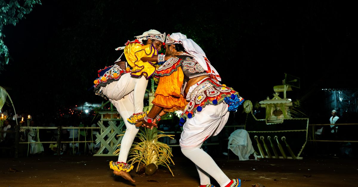 Colorful traditional Kandyan dancers performing a cultural dance at night in Gampaha, Sri Lanka.