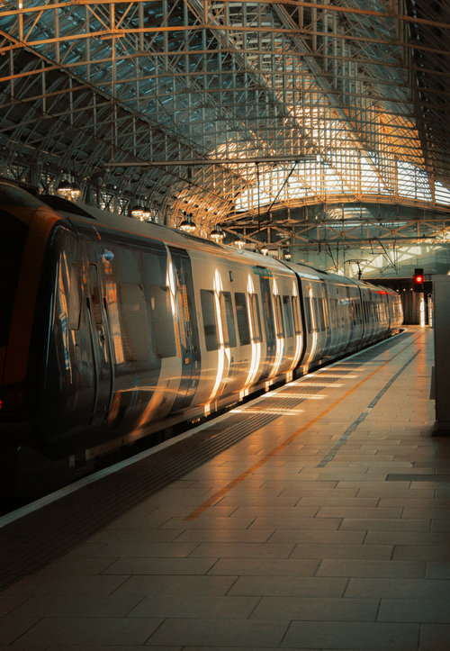 Free A sunlit train parked at the iconic Manchester Piccadilly Station in the UK. Stock Photo
