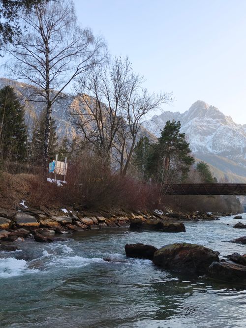 Free Beautiful view of the river with an alpine backdrop in Tyrol, Austria, capturing serene nature in early spring. Stock Photo