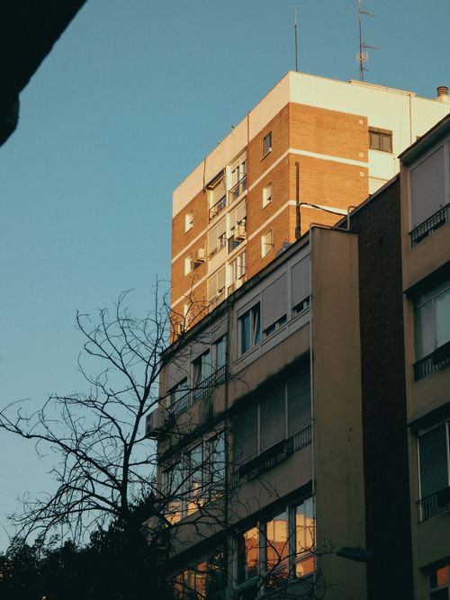 Free A residential building in Madrid captured at sunset, casting warm hues over the architecture. Stock Photo