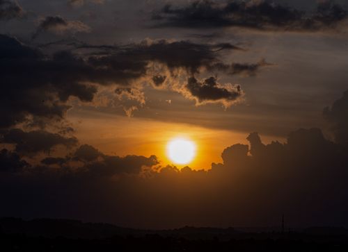 Free Stunning sunset with dramatic clouds creating a vibrant silhouette in the evening sky. Stock Photo