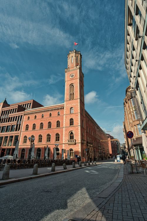 Free Stunning view of a historic red brick tower building under a clear blue sky in Hamburg. Stock Photo